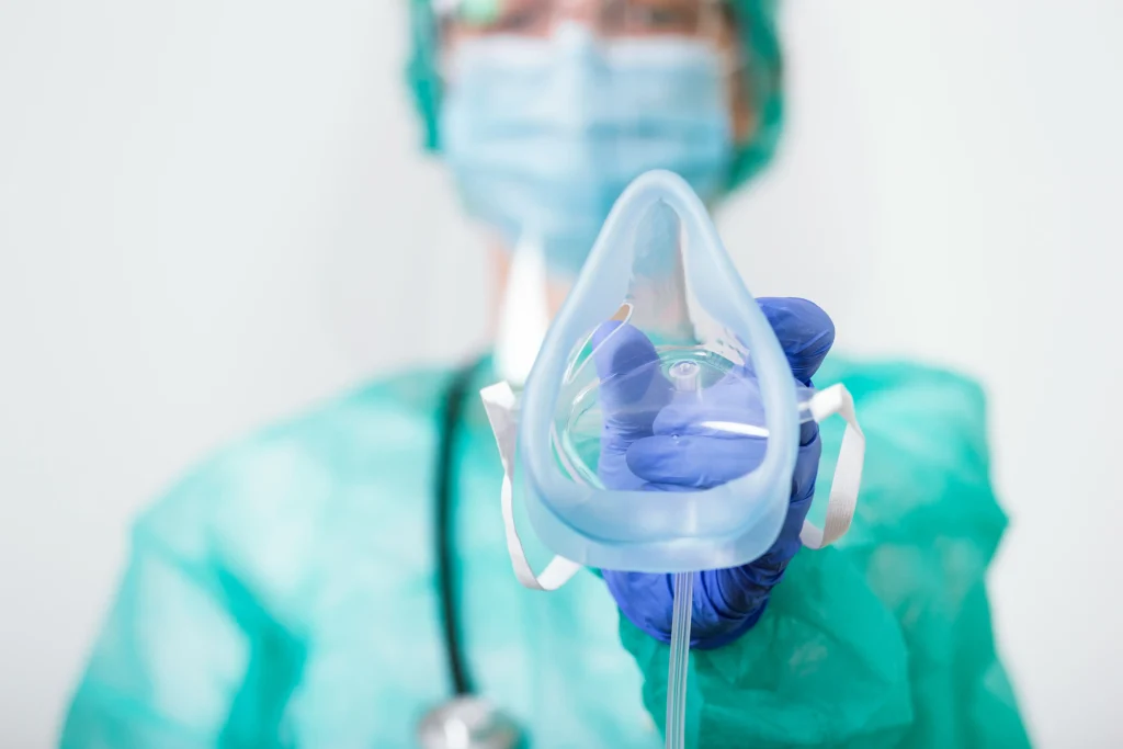 doctor woman holds oxygen mask inhale breath problem patient coronavirus covid 19 attack lungs min